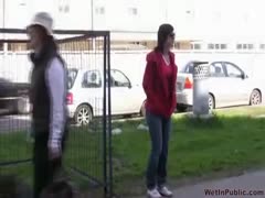 A Russian amateur wife urinates in her jeans while strolling along the sidewalk.